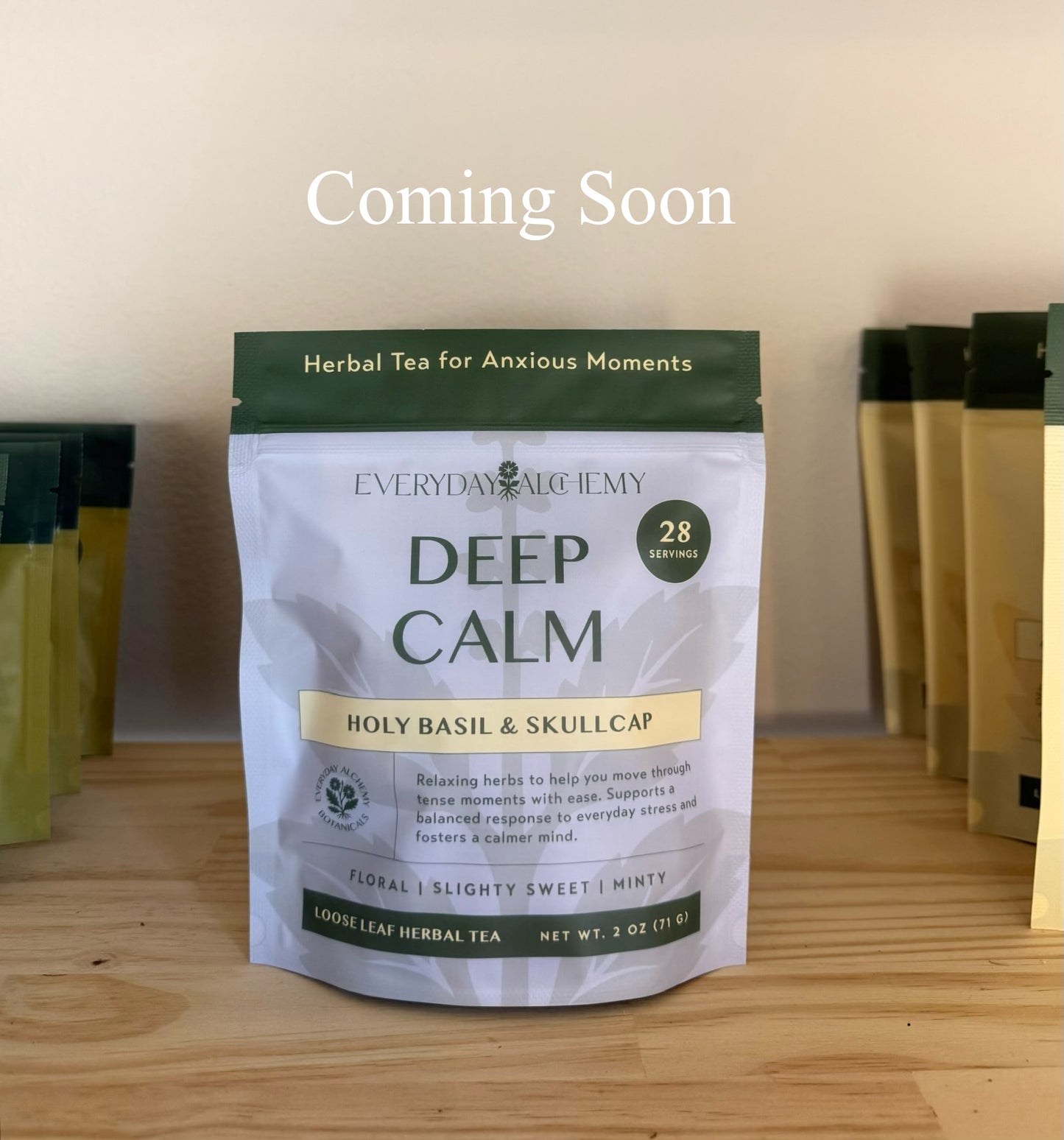 Package of 'Deep Calm' herbal tea from Everyday Alchemy on a wooden surface with 'Coming Soon' text above.