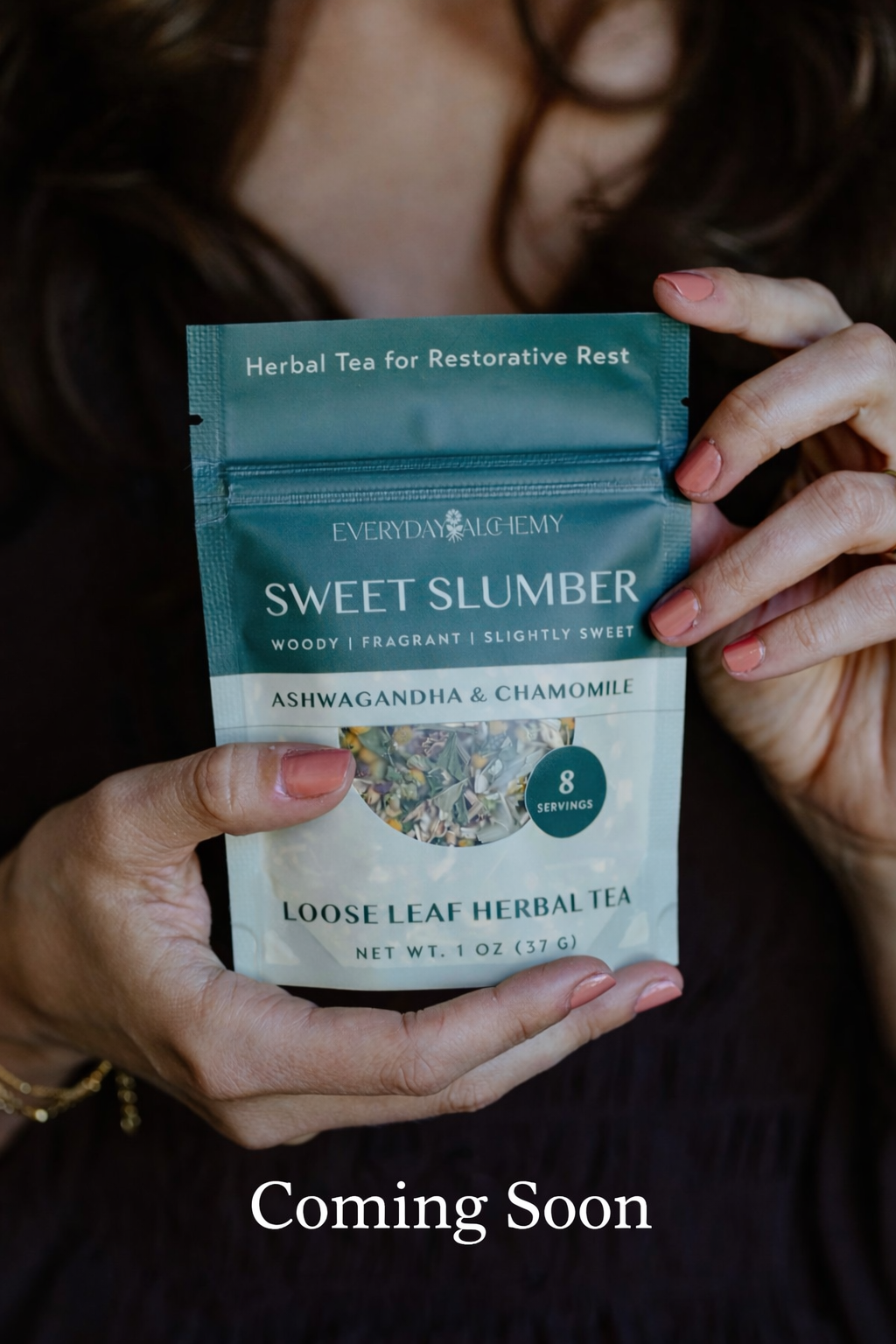 Person holding a package of 'Sweet Slumber' herbal tea with a blurred background